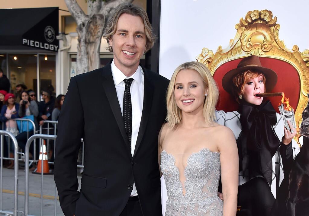 FILE - In this March 28, 2016, file photo, Dax Shepard, left, and Kristen Bell arrive at the world premiere of 'The Boss' at the Regency Village Theatre on Monday, in Los Angeles. Bell publicly revealed photos of her 2013 wedding to Shepard during a profile on CBS' 'Sunday Morning' July 24, 2016. (Photo by Jordan Strauss/Invision/AP, File)