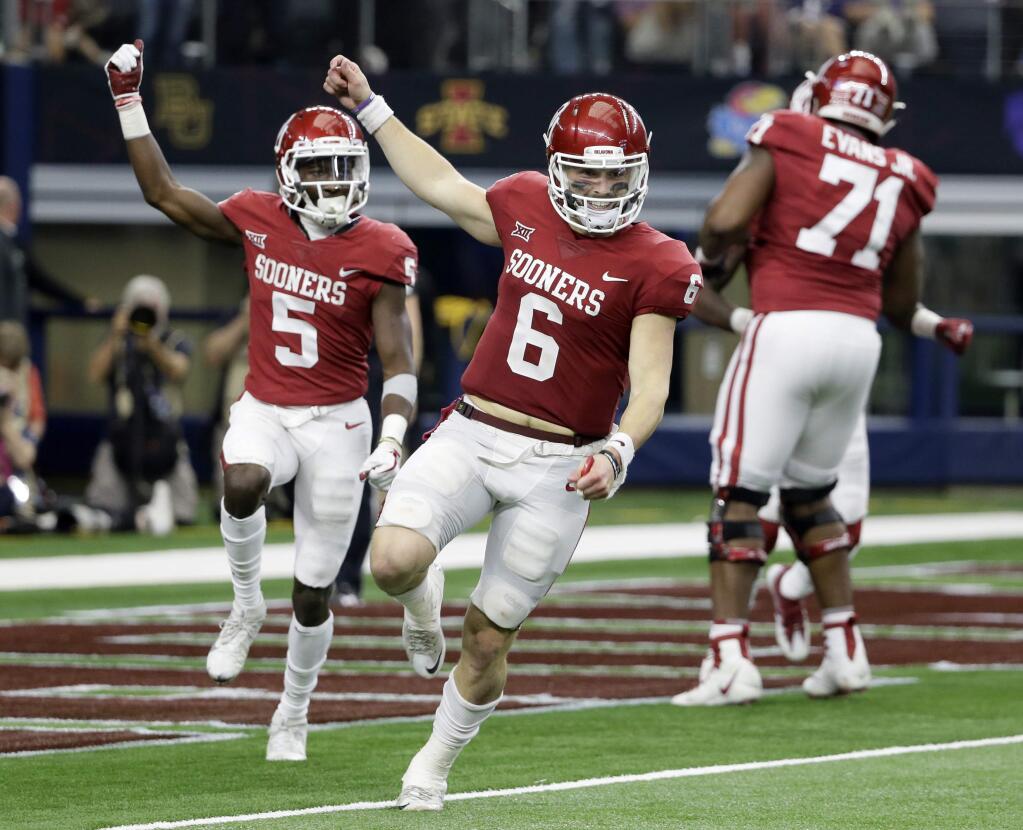 Oklahoma quarterback Baker Mayfield (6) and wide receiver Marquise Brown (5) celebrate hooking up for a long pass and touchdown score in the second half of the Big 12 Conference championship game against TCU on Saturday, Dec. 2, 2017, in Arlington, Texas. (AP Photo/Tony Gutierrez)