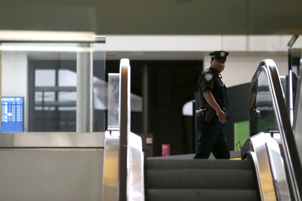 A police officer patrols a terminal at Newark Liberty International Airport, Wednesday, June 29, 2016, in Newark, N.J. Following the Istanbul airport terrorist attack on Tuesday, travel experts say still take that trip but always be valiant about surroundings. A few key tricks can help to make the trip safer. (AP Photo/Julio Cortez)