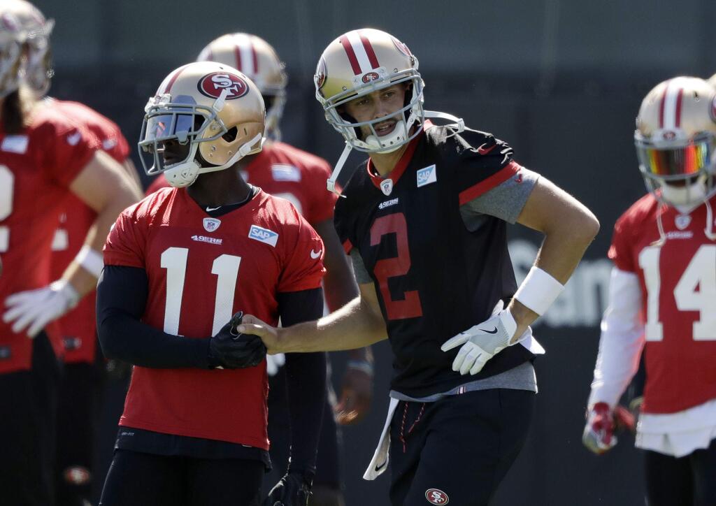 San Francisco 49ers quarterback Brian Hoyer shakes hands with wide receiver Marquis Goodwin during the team's training camp Friday, July 28, 2017, in Santa Clara. (AP Photo/Marcio Jose Sanchez)