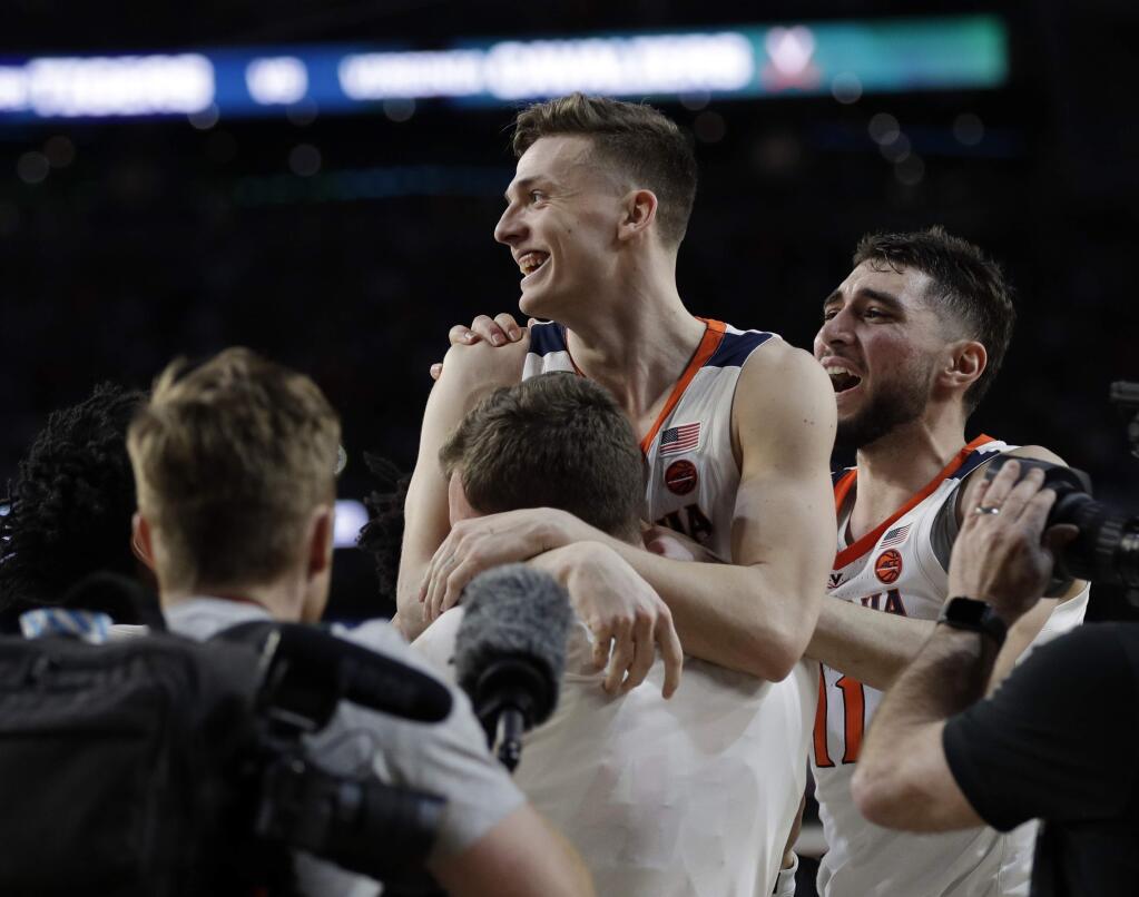 Virginia's Kyle Guy celebrates after defeating Auburn 63-62 in the semifinals of the Final Four at the NCAA Tournament, Saturday, April 6, 2019, in Minneapolis. (AP Photo/David J. Phillip)