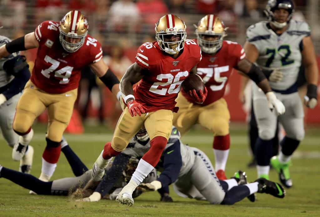 Tevin Coleman of the 49ers gets a first down during the second half in a 27-24 loss to Seattle, Monday, Nov. 11, 2019 in Santa Clara. (Kent Porter / The Press Democrat)