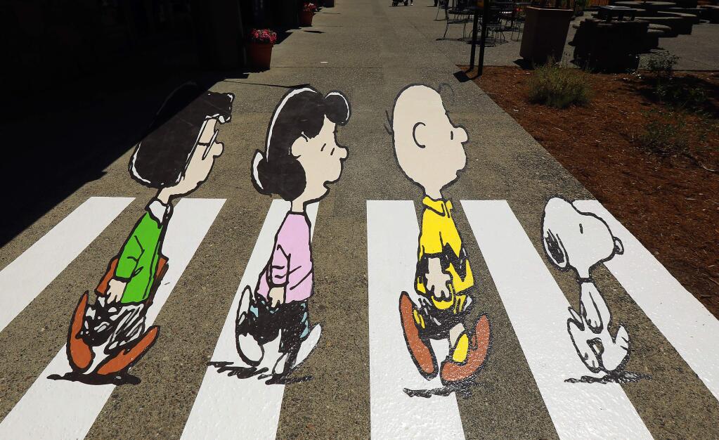 A new 3-D painting on the sidewalk in front of Snoopy's Home Ice in Santa Rosa mimics the Beatles 'Abbey Road' cover with the characters created by Charles M. Schulz. (John Burgess/The Press Democrat)