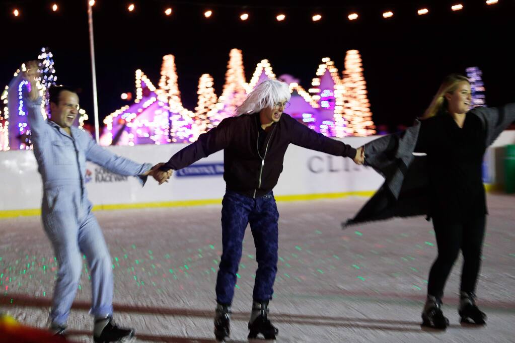 Austin Carrier, left, Alex Mutter-Rottmayer and Caitlin Boucher hold hands as they ice skate at Cornerstone Sonoma in Sonoma, California on Friday, December 8, 2017. (Alvin Jornada / The Press Democrat)