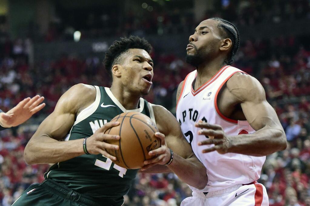 Milwaukee Bucks forward Giannis Antetokounmpo drives to the basket as Toronto Raptors forward Kawhi Leonard defends during the first half of Game 4 of the Eastern Conference finals, Tuesday, May 21, 2019 in Toronto. (Frank Gunn/The Canadian Press via AP)