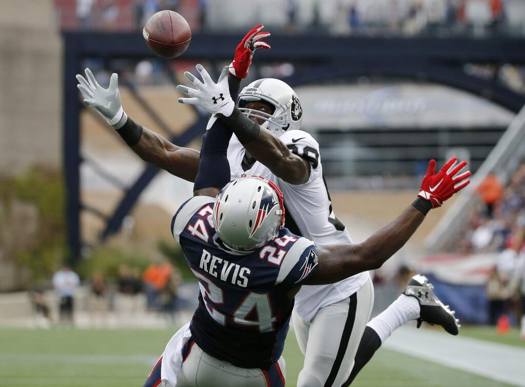 New England Patriots cornerback Darrelle Revis (24) breaks up a pass to Oakland Raiders wide receiver James Jones (89) in the end zone in the fourth quarter of an NFL football game Sunday, Sept. 21, 2014, in Foxborough, Mass. (AP Photo/Elise Amendola)