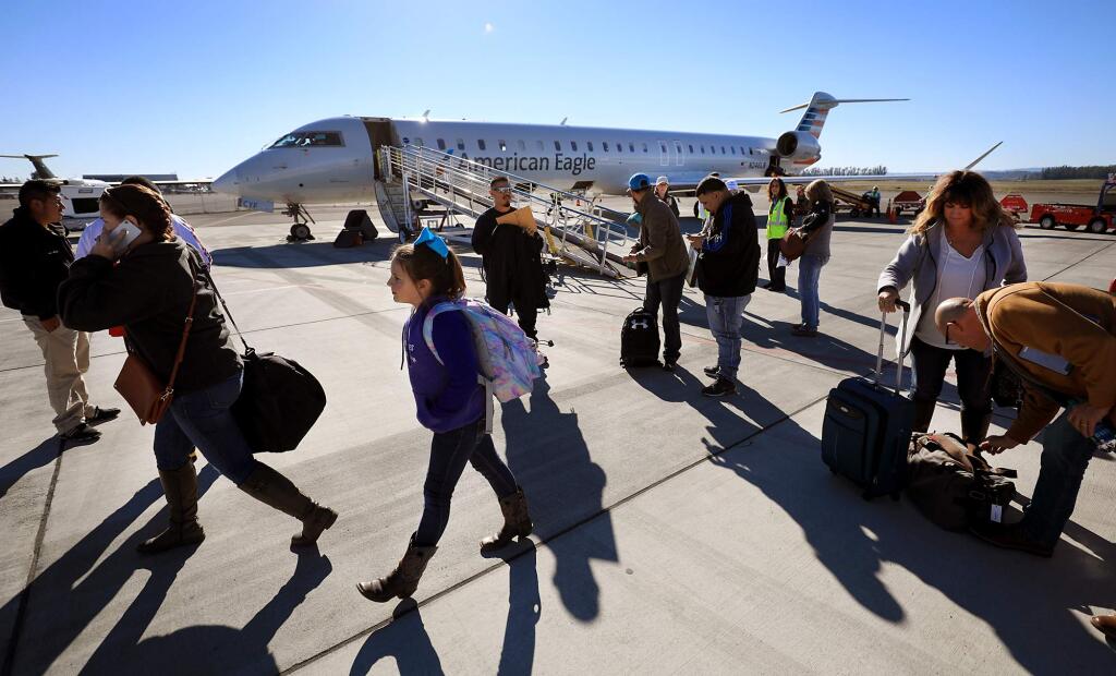 American Airlines passengers deplane at the Charles M. Schulz-Sonoma County Airport,  in Santa Rosa, Thursday, Dec. 13, 2018. The airline has pushed back the 2024 return date of its seasonal Dallas flight, but also plans to use bigger planes at the facility next year. (Kent Porter / The Press Democrat file)