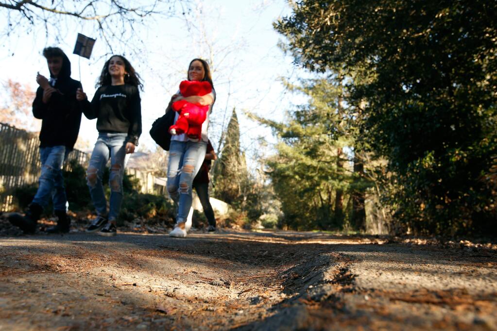 Students from Lawrence E Jones Middle School walk by an uneven patch of pavement on the Crane Creek path in Rohnert Park, California, on Wednesday, February 14, 2018. (Alvin Jornada / The Press Democrat)