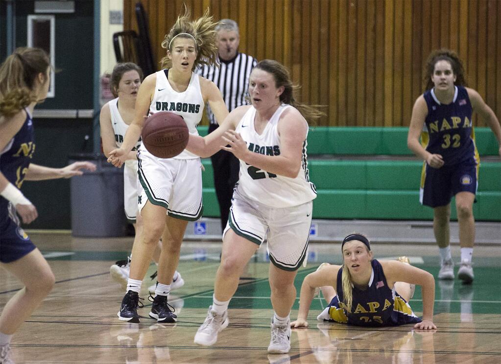 Annie Neles (21) charges toward the basket in a game against Napa earlier this season, with Shauna Johnston behind her and Erin Glyfe trailing. The Lady Dragons are entering the season's second half with an 8-7 record, but their toughest competition lies ahead. (Photo by Robbi Pengelly/Index-Tribune)