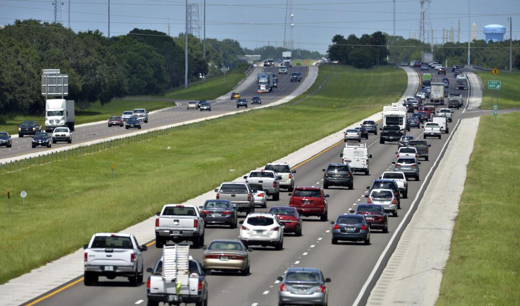 Northbound traffic, right, on I-75 through Sarasota, Fla., is heavier than normal, but still moving on Thursday, Sept. 7, 2017. Many South Florida residents are evacuating and heading north as Hurricane Irma approaches. (Mike Lang /Sarasota Herald-Tribune via AP)
