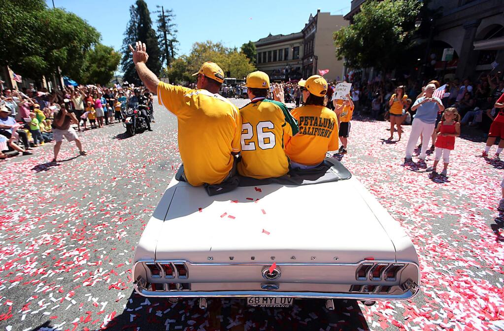 Bradley Smith, middle waves to the crowd as an estimated 15,000 people in Petaluma cheer the Petaluma National Little League during a victory parade, Sunday, Sept. 2, 2012 after their historic run through the Little League World Series. (Kent Porter / Press Democrat)