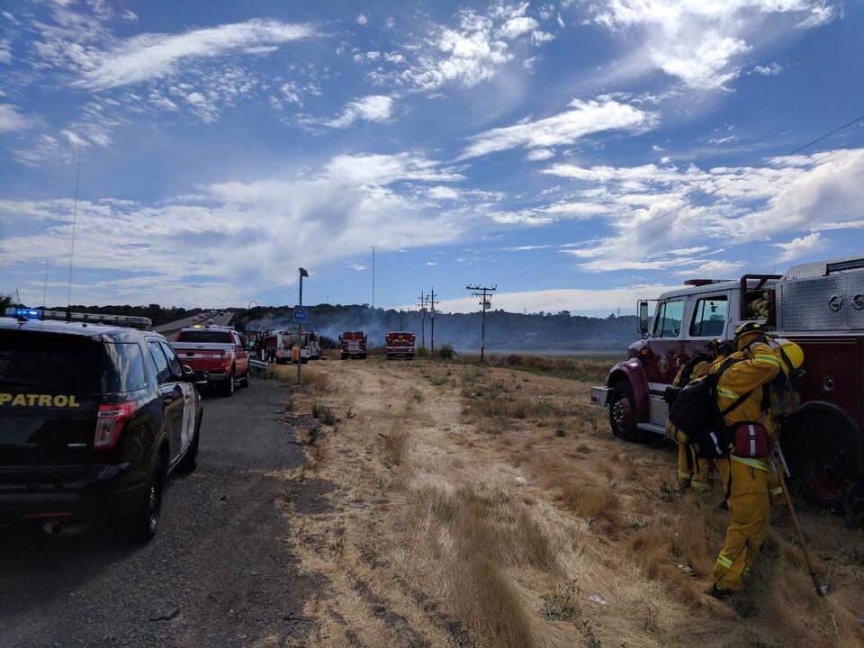 Firefighters respond to a brush fire near Highway 37 and a bridge over the Petaluma River Saturday. (Photo courtesy of the CHP)
