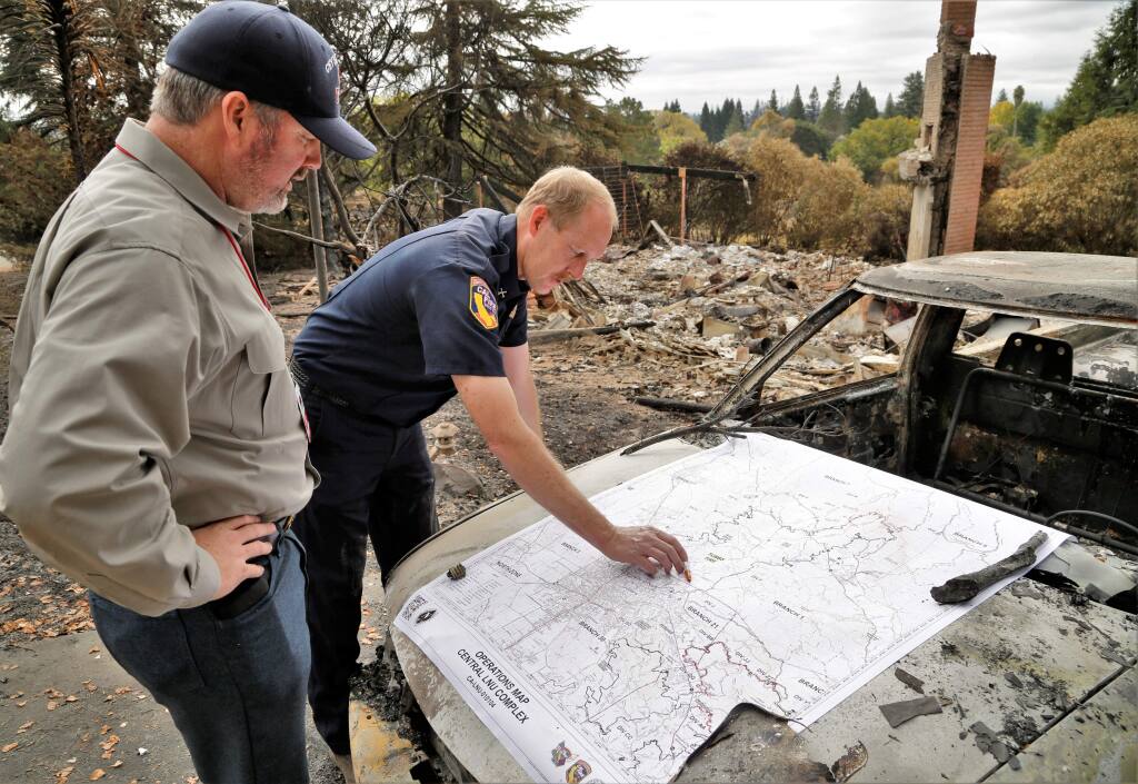 Cal Fire Battalion Chief Paul Fleckenstein, right, shows a map of the fire zones to Sonoma County 4th District Supervisor James Gore Thursday October 19th, 2017. (Photo Will Bucquoy/for the Press Democrat).