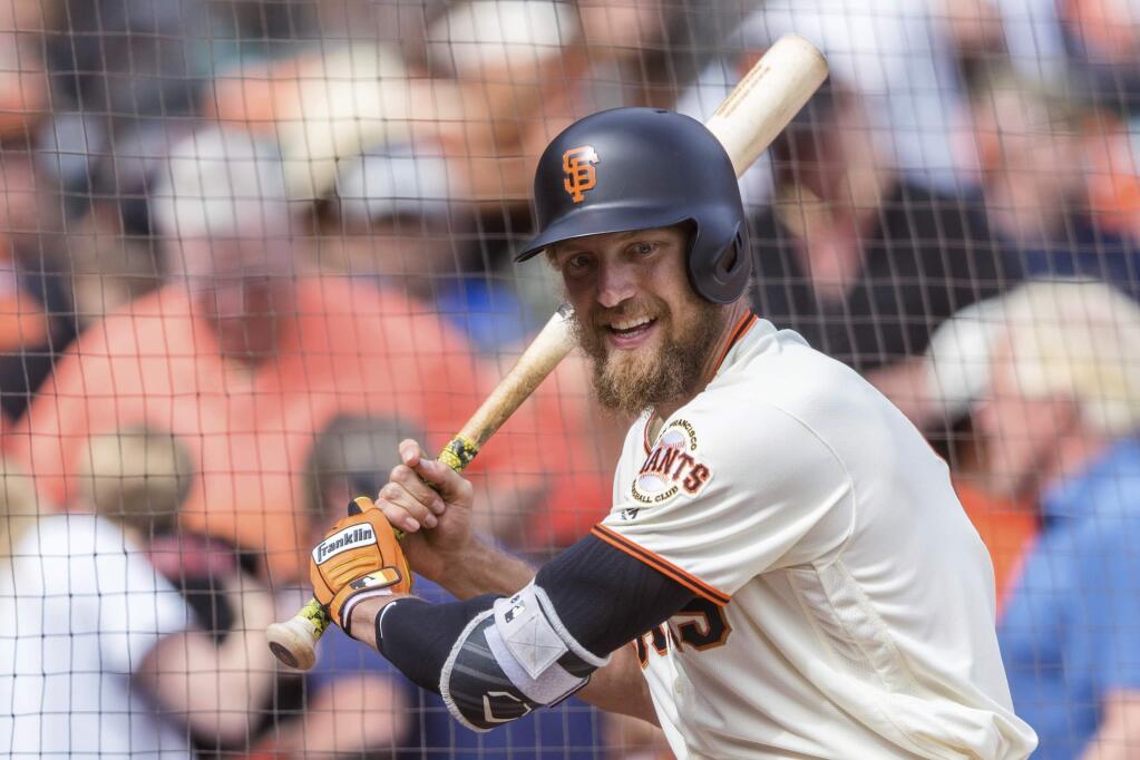 In this Sept. 30, 2018, file photo, San Francisco Giants Hunter Pence waits on deck before batting against the Los Angeles Dodgers in the ninth inning in San Francisco. Pence is returning to the Giants, agreeing to a contract that will give the young club a veteran presence in both the outfield and clubhouse in a season of big change ahead. (AP Photo/John Hefti)