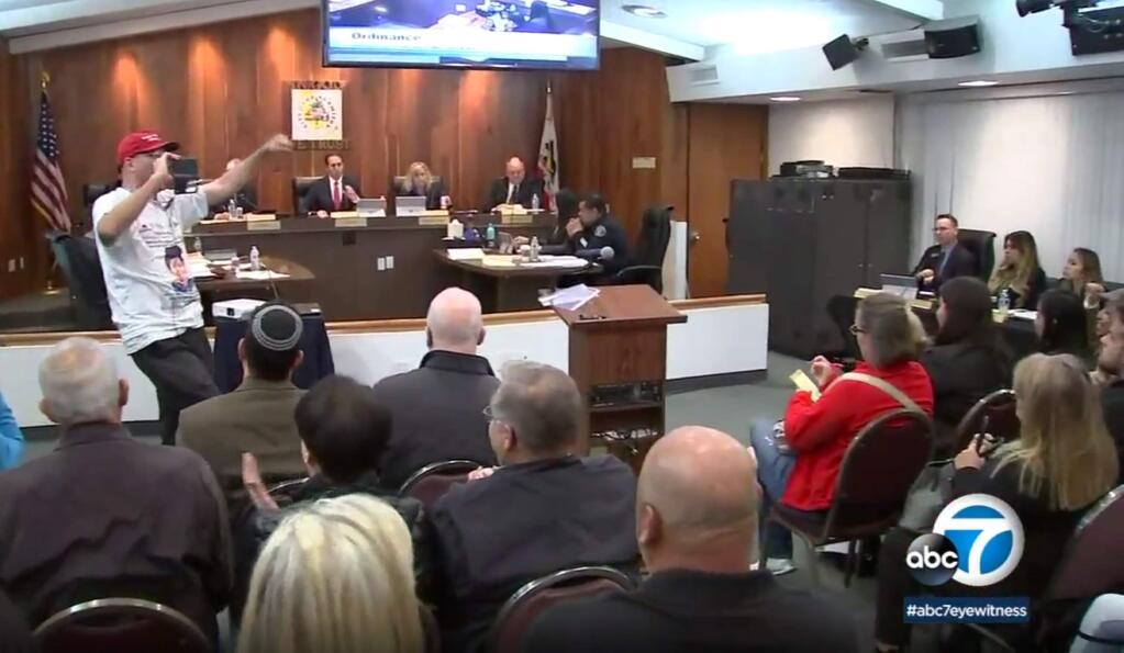 In this Monday, March 19, 2018 image made from video provided by KABC-7 councilmembers listen during a meeting in Los Alamitos, Calif. Leaders of the small California city in Orange County have given preliminary approval to a measure to exempt the city from a state law that limits cooperation between local police and federal immigration agents. Councilmembers voted 4-1 Monday night in favor of an ordinance to opt out of California's law, citing constitutional concerns. A required second vote is expected on April 16. (KABC-7 via AP)