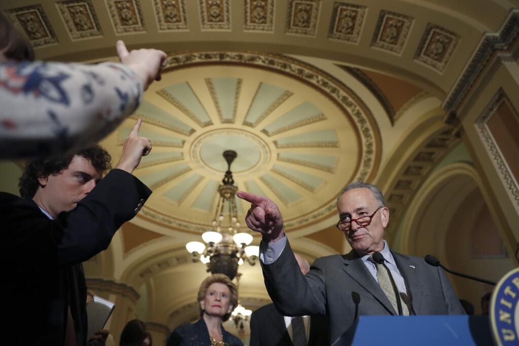 Senate Minority Leader Charles Schumer of N.Y., accompanied by Sen. Debbie Stabenow, D-Mich., points to a reporter during a media availability after a policy luncheon on Capitol Hill in Washington, Tuesday, April 25, 2017. (AP Photo/Alex Brandon)