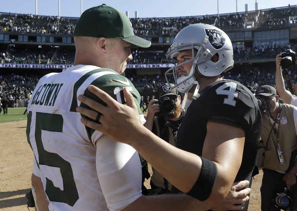 New York Jets quarterback Josh McCown, left, greets Oakland Raiders quarterback Derek Carr after a game in Oakland, Sunday, Sept. 17, 2017. (AP Photo/Marcio Jose Sanchez)