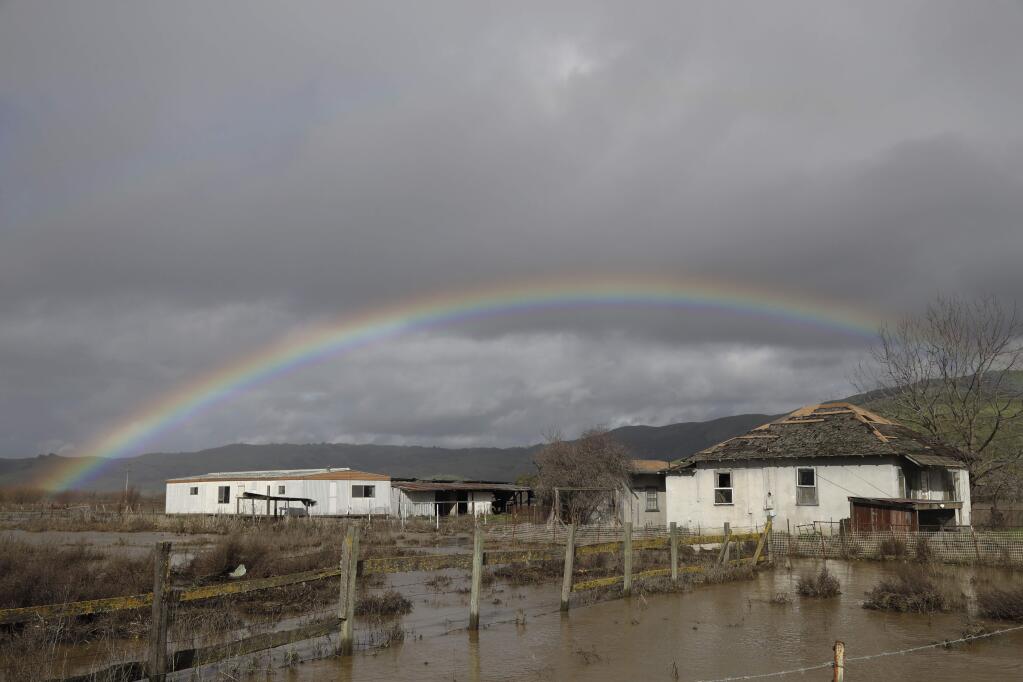 FILE - In this Jan. 11, 2017, file photo, a rainbow is seen over a flooded landscape in Hollister, Calif. More than 40 percent of California has emerged from a punishing drought that covered the whole state a year ago, federal drought-watchers said Thursday, Jan. 12, a stunning transformation caused by an unrelenting series of storms in the North that filled lakes, overflowed rivers and buried mountains in snow. (AP Photo/Marcio Jose Sanchez, File)
