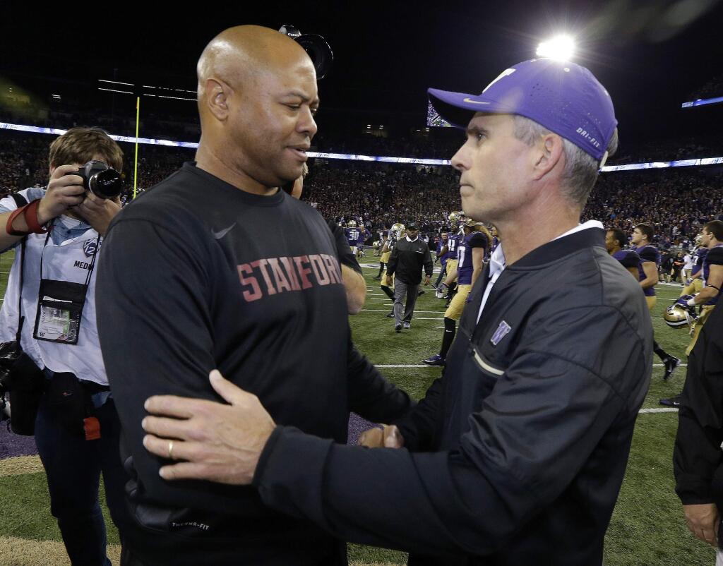 In this Sept. 30, 2016, file photo, Washington coach Chris Petersen, right, shakes hands with Stanford coach David Shaw after the Huskies' 44-6 win in in Seattle. Stanford looks to use a short week before hosting No. 9 Washington to put last week's loss at Washington State and last year's defeat against the Huskies in the past. (AP Photo/Ted S. Warren, File)