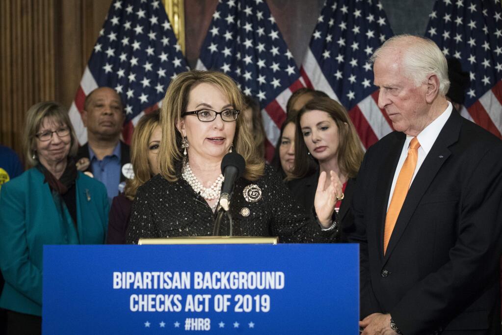 Former Rep. Gabby Giffords and Rep. Mike Thompson at Tuesday's news conference unveiling legislation requiring a background check on all firearms sales. (SARAH SILBIGER / New York Times)