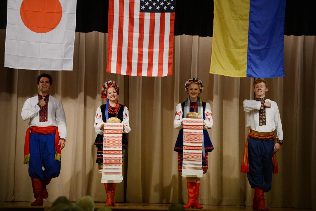 Members of the Burevisnyky Ukrainian Dance Ensemble performing beneath the Japanese, American and Ukrainian flags during the Sister City Friendship Dinner held at the Enmanji Buddhist Temple in Sebastopol, California. The fundraising event celebrates Sebastopol's sister city relationships with Takeo, Japan and Chyhyryn, Ukraine. November 3, 2018.(Photo: Erik Castro/for The Press Democrat)