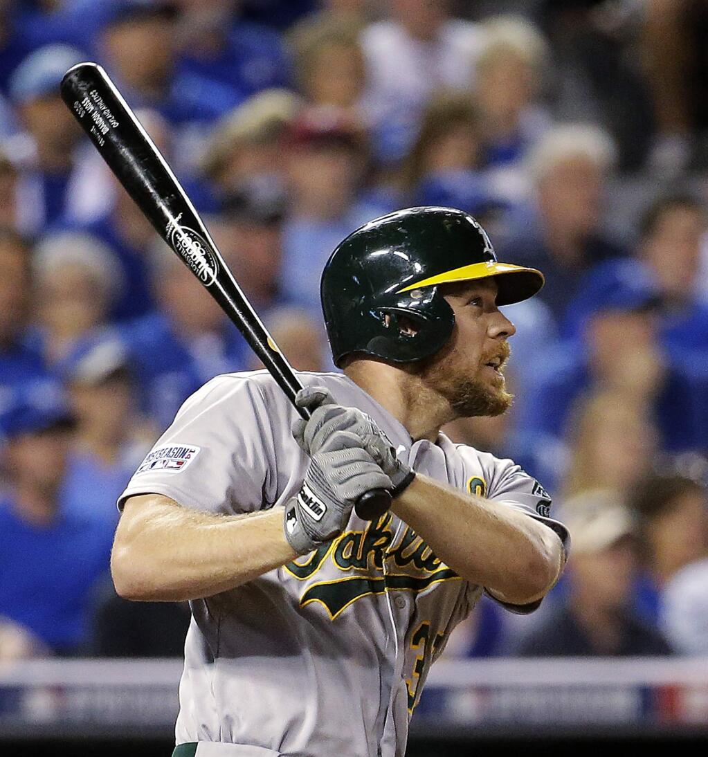 Oakland Athletics' Brandon Moss watches his three-run home run during the sixth inning of the AL wild-card playoff baseball game against the Kansas City Royals on Tuesday, Sept. 30, 2014, in Kansas City, Mo. (AP Photo/Charlie Riedel)