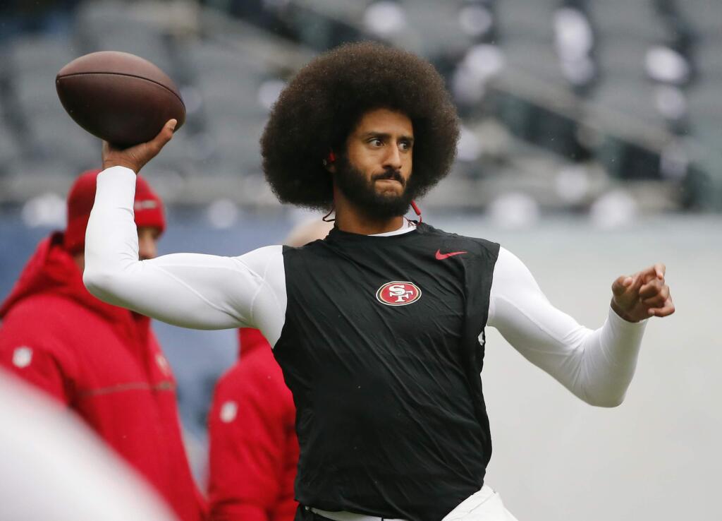 In this Dec. 4, 2016, file photo, San Francisco 49ers quarterback Colin Kaepernick warms up before an NFL football game against the Chicago Bears. Spike Lee said on Instagram Sunday, March 19, 2017, that it was 'fishy' that Kaepernick, now a free agent, hadn't been signed. (AP Photo/Charles Rex Arbogast, File)
