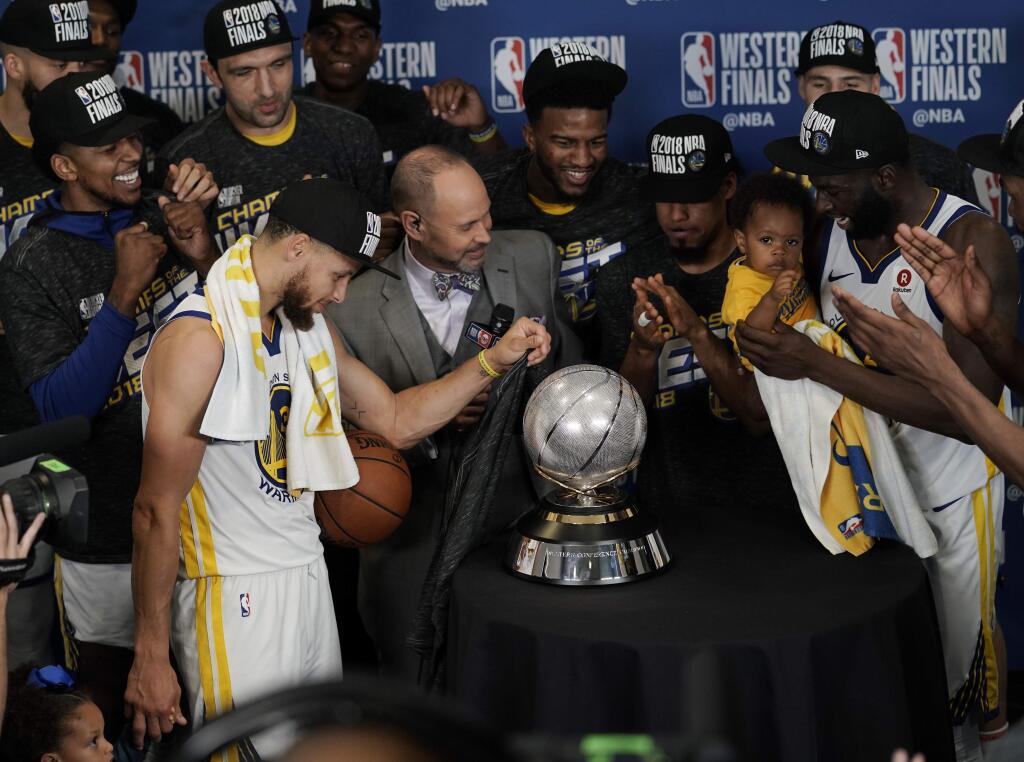 The Golden State Warriors pose with their trophy after defeating the Houston Rockets in Game 7 of the NBA basketball Western Conference finals, Monday, May 28, 2018, in Houston. (AP Photo/David J. Phillip)