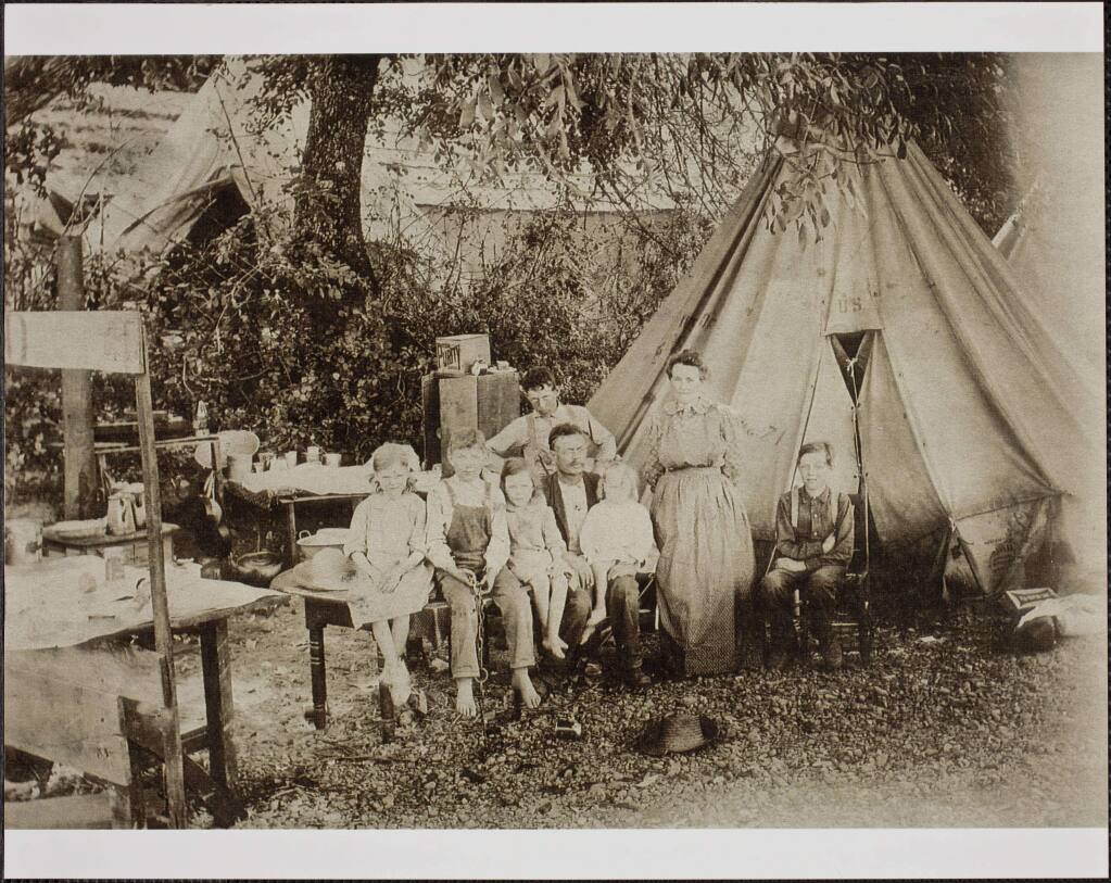 The Hollingsworth family poses in a migrant farm worker camp near Hopland, circa 1906. Seated left to right: Veda Jeanette (1899-1997); Harry Mervyn (1897-1963); Wilma Lynn (1902-1959); William Theron, father (1868-1922) Jack Morton, seated on father's lap (1904-1970); Arthur Rollin, standing behind father (1891-1961) Ida Eliza, mother, standing (1863-1944) Grover Geary, seated in a chair (1893-1968). (Rodd Collection, Sonoma County Library)