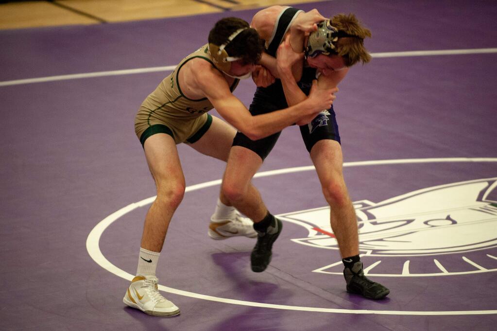 ANDREW GOTSHALL/FOR THE ARGUS-COURIERPetaluma's Charlie Winter and Casa Grande's Collin Hilliard lock up in their 115-pound match won by Winter, 3-0.
