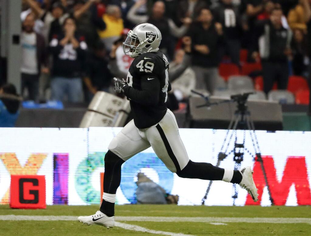 Oakland Raiders fullback Jamize Olawale scores a touchdown during the second half against the Houston Texans Monday, Nov. 21, 2016, in Mexico City. (AP Photo/Eduardo Verdugo)