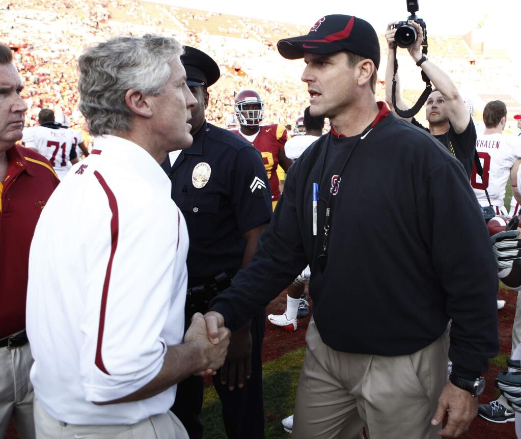 USC coach Pete Carroll, left, and Stanford coach Jim Harbaugh greet each other after a game in Los Angeles on Saturday, Nov. 14, 2009. Stanford won 55-21. (AP Photo/Matt Sayles)