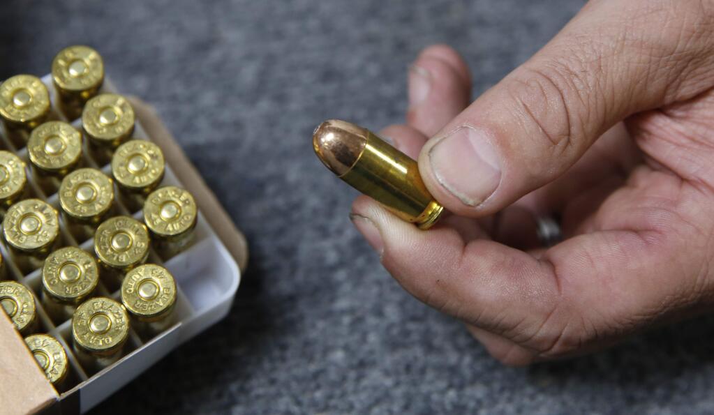 In this photo taken Tuesday, June 11, 2019, Chris Puehse, owner of Foothill Ammo displays a .45 caliber bullet for sale at his store in Shingle Springs, Calif. Californians will have to undergo criminal background checks every time they buy ammunition starting July 1 under a 2016 voter-approved ballot initiative. (AP Photo/Rich Pedroncelli)