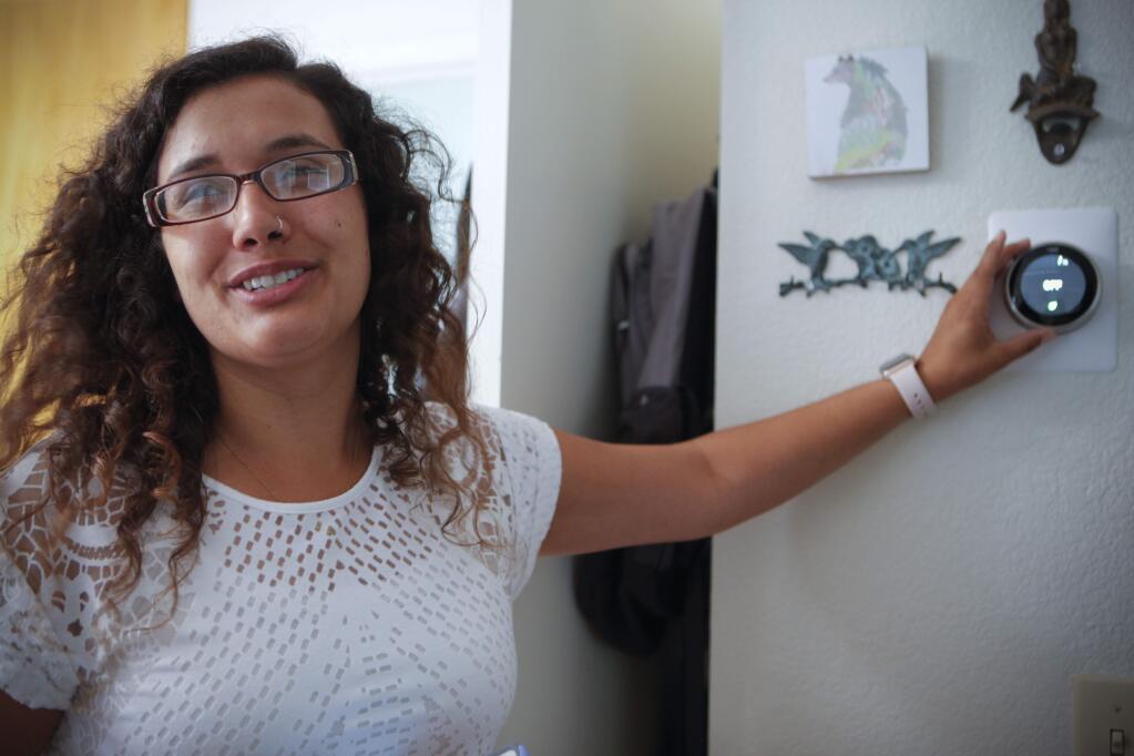 The PEP Housing 'smart home' project is now in its second phase. Morgan Lemos, a property manager demonstrates the many uses of the new high-tech gear that was installed in her apartment to be tested.(CRISSY PASCUAL/ARGUS-COURIER STAFF)