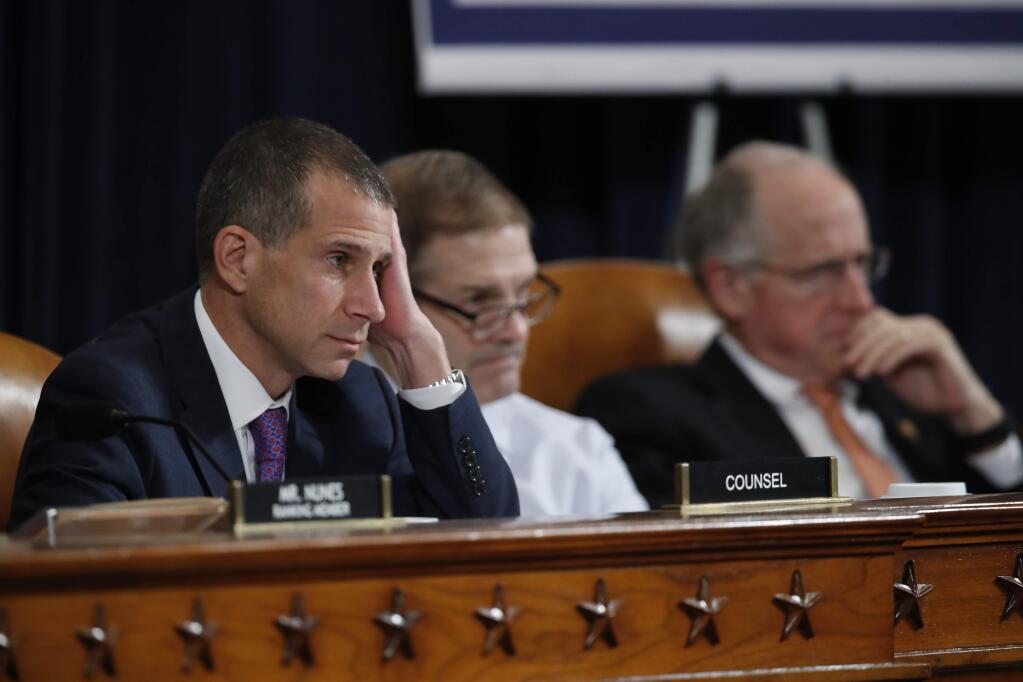 From left, Steve Castor, the Republican staff attorney, Rep. Jim Jordan, R-Ohio, and Rep. Mike Conaway, R-Texas, listen as U.S. Ambassador to the European Union Gordon Sondland testifies before the House Intelligence Committee on Capitol Hill in Washington, Wednesday, Nov. 20, 2019, during a public impeachment hearing of President Donald Trump's efforts to tie U.S. aid for Ukraine to investigations of his political opponents. (AP Photo/Alex Brandon)