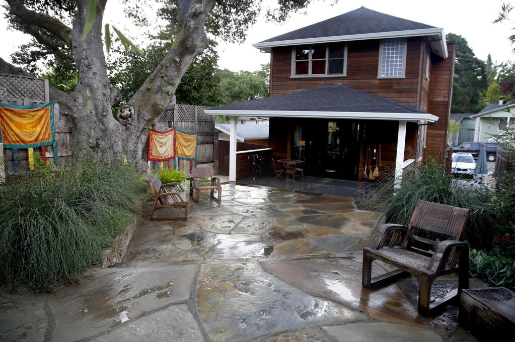 Lynne Bernstein, owner of Garden of Ease Landscaping and Design, used stone terraces and plantings to give a new look to the backyard of Lisa Clyde in Sebastopol on Thursday, Aug. 14, 2014. (BETH SCHLANKER / The Press Democrat)