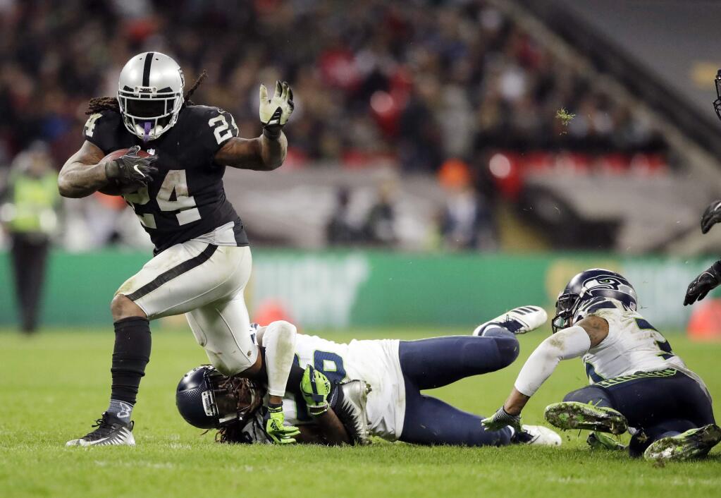 Oakland Raiders running back Marshawn Lynch is tackled by Seattle Seahawks cornerback Shaquill Griffin during the second half at Wembley stadium in London, Sunday, Oct. 14, 2018. (AP Photo/Matt Dunham)