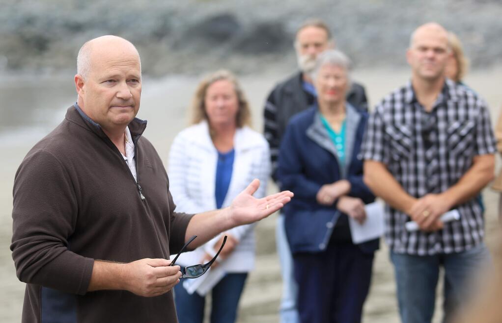 Sonoma County Sheriff Steve Freitas talks with relatives and friends of the Cutshall family during a memorial for Lindsay Cutshall and Jason Allen at Goat Rock on Friday, Aug. 15, 2014. (KENT PORTER/ PD)