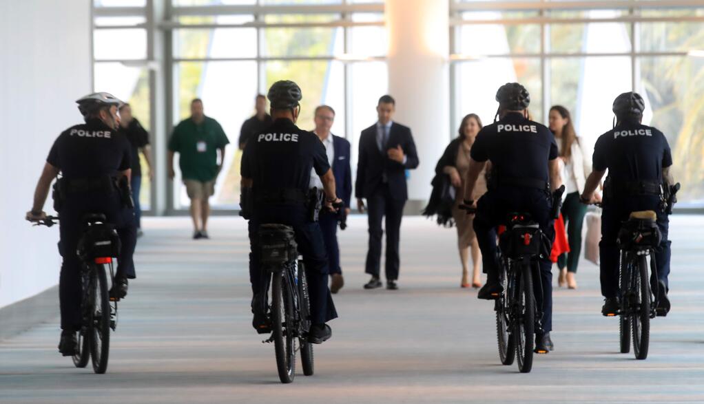 Part of Miami Police Department's bike patrol cruises through the hallway of the Convention Center in Miami Beach, Monday, Jan. 27, 2020 in Miami. (Kent Porter / The Press Democrat)