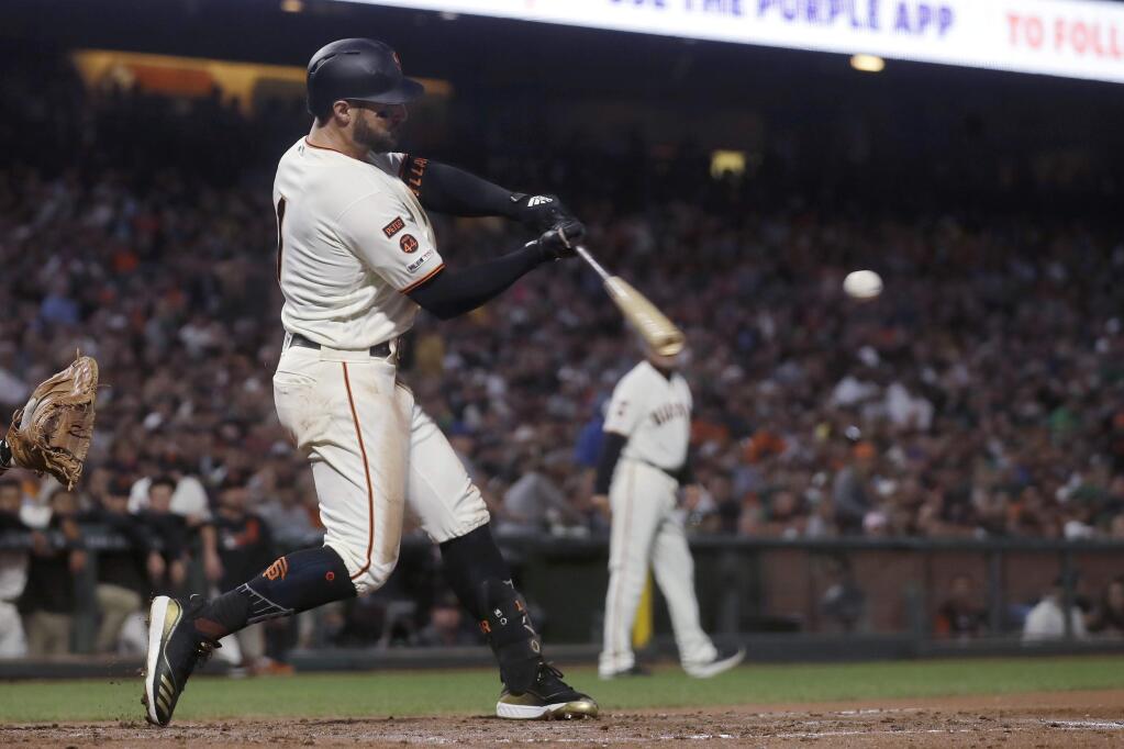 San Francisco Giants' Kevin Pillar hits a double to score Evan Longoria against the Oakland Athletics during the sixth inning of a baseball game in San Francisco, Tuesday, Aug. 13, 2019. (AP Photo/Jeff Chiu)