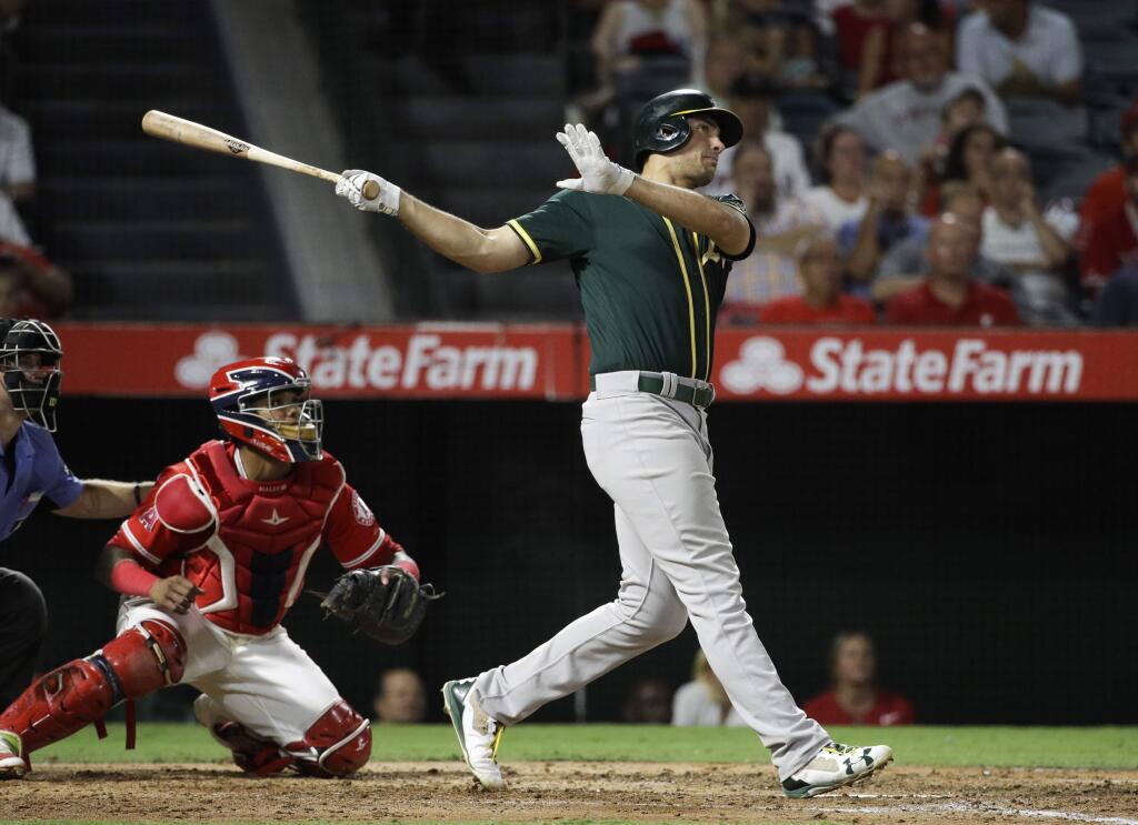 The Oakland Athletics' Matt Olson watches his three-run home run during the fourth inning of a game against the Los Angeles Angels, Wednesday, Aug. 30, 2017, in Anaheim. (AP Photo/Jae C. Hong)