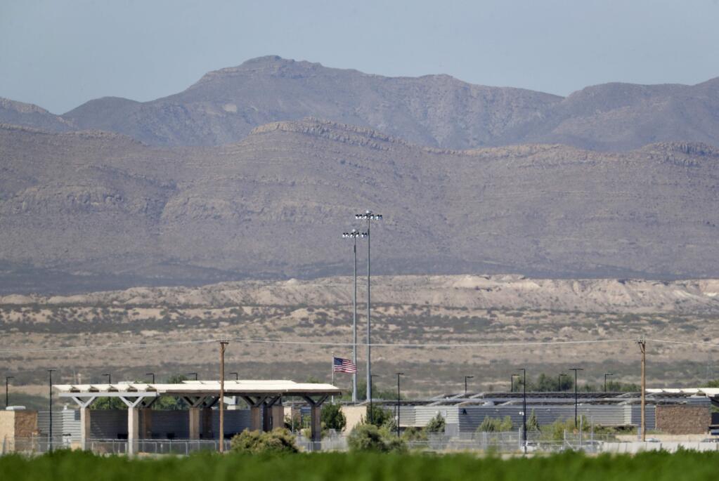 Mexico backdrops the Fabens Port-of-Entry which houses tent shelters used to hold separated migrant family members along the International border, Friday, June 22, in Fabens, Texas. The U.N human rights office says President Donald Trump's decision to stop the U.S. policy separating migrant parents from their children doesn't go far enough. (AP Photo/Matt York)