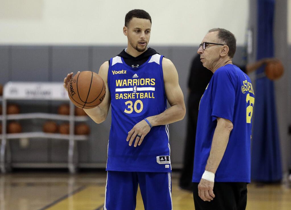 The Golden State Warriors' Stephen Curry, left, speaks with assistant coach Ron Adams during practice on Friday, May 13, 2016, in Oakland. (AP Photo/Ben Margot)