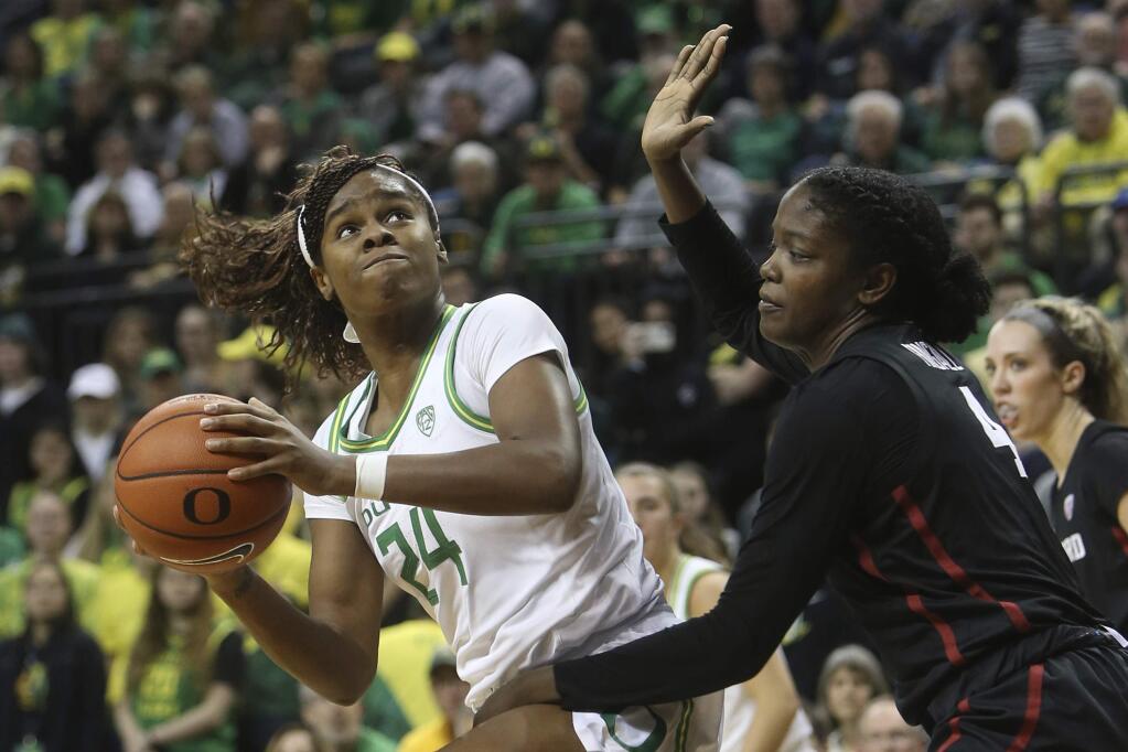 Oregon's Ruthy Hebard, left, looks for a shot against Stanford's Nadia Fingall during the second quarter in Eugene, Ore., Thursday, Jan. 16, 2020. (AP Photo/Chris Pietsch)