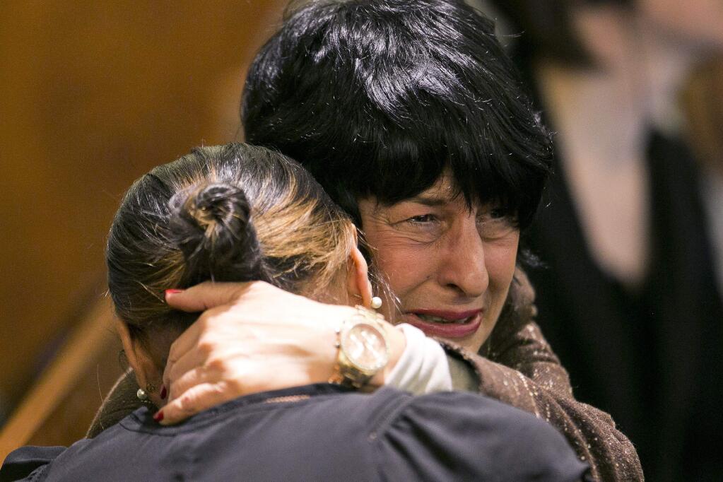 Terri Hernandez, mother of former New England Patriots football player Aaron Hernandez hugs Shayanna Jenkins, Hernandez's fiancee, as the guilty verdict is read at the Bristol County Superior Court in Fall River, Mass., Wednesday, April 15, 2015. Hernandez was found guilty of first-degree murder in the shooting death of Odin Lloyd in June 2013. He faces a mandatory sentence of life in prison without parole. (Dominick Reuter/Pool Photo via AP)