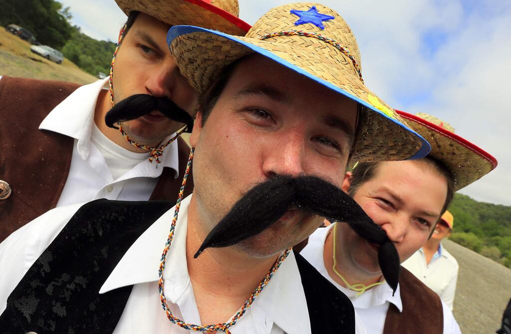 (l to r) Andy Priest, Cody Zardo and Michael Zardo of Bella Vineyards wore aerodynamic mustaches for The Great Russian River Race at Rio Lindo Beach on Saturday. (JOHN BURGESS / The Press Democrat)