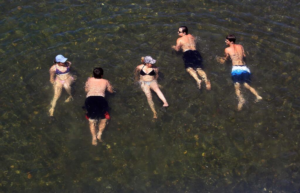 A group of friends from Rohnert Park take advantage of the cool Russian River at Memorial Beach in Healdsburg, Monday June 19, 2017 as the heat wave continues. (Kent Porter / Press Democrat) 2017