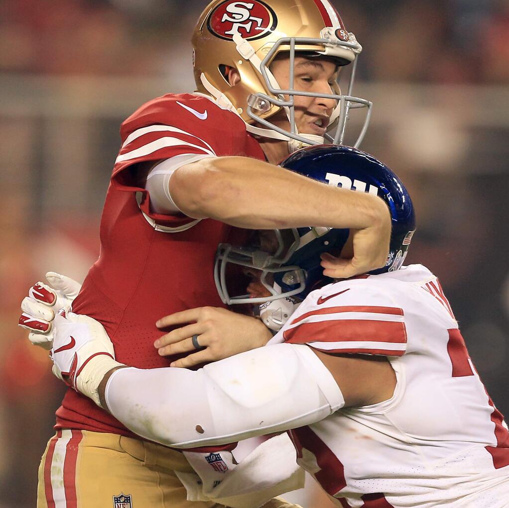 49ers quarterback Nick Mullens is hit hard by Kerry Wynn of the Giants after releasing the ball during San Francisco's 27-23 loss over New York, Monday, Nov. 12, 2018. (Kent Porter / The Press Democrat) 2018