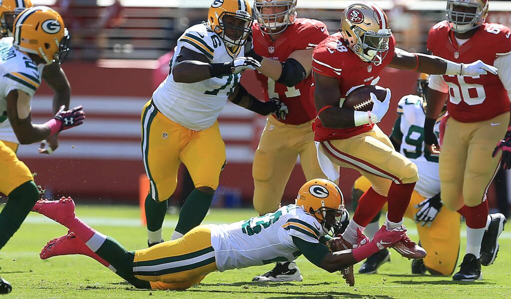 Carlos Hyde of the Niners is tackled by Damarious Randall during the Packers 17-3 win at Levi Stadium in Santa Clara, Sunday Oct. 4, 2015. (Kent Porter / Press Democrat) 2015