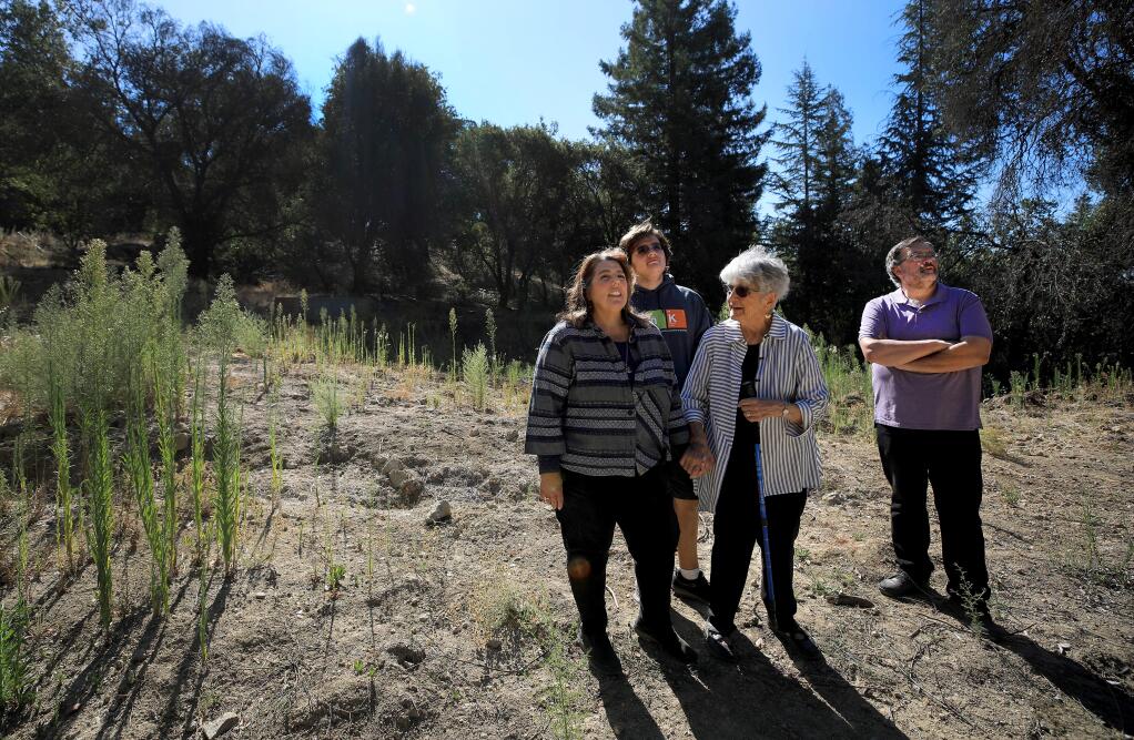 Lisa Frazee, son Carl, 16, mom, Gloria Sanchez, and Howard Frazee at their Tubbs fire Wikiup lot on Saturday, Sept. 21, 2019. (KENT PORTER/ PD)